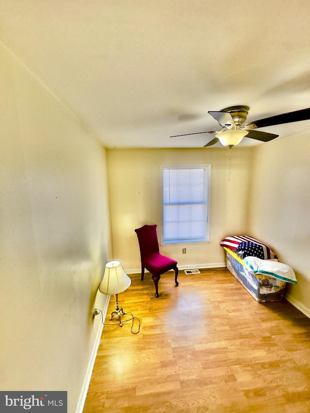 sitting room featuring ceiling fan and light hardwood / wood-style floors