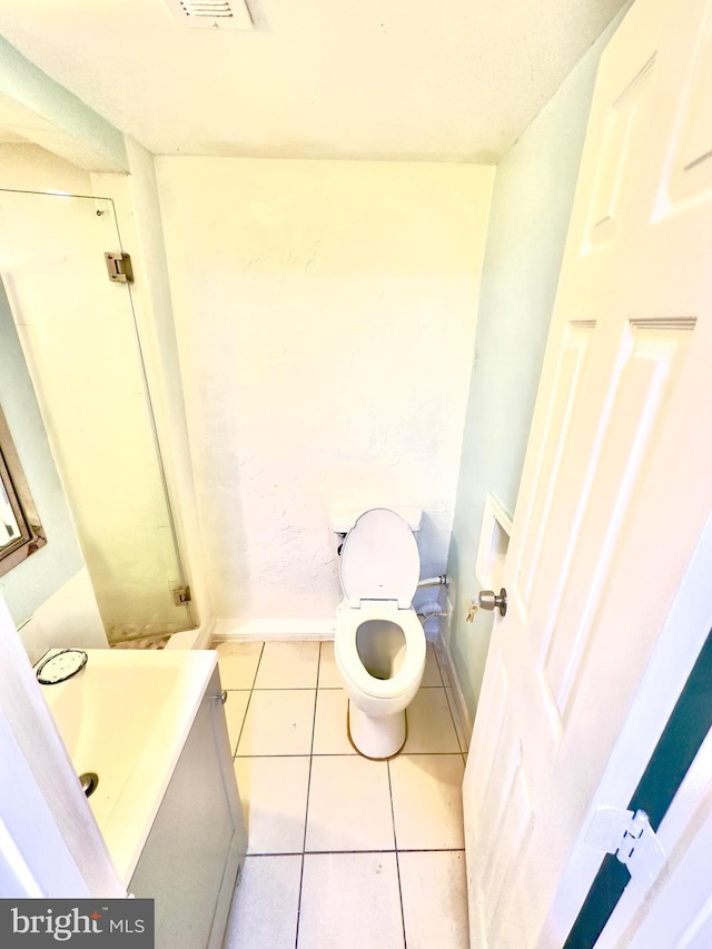 bathroom with vanity, tile patterned floors, and toilet