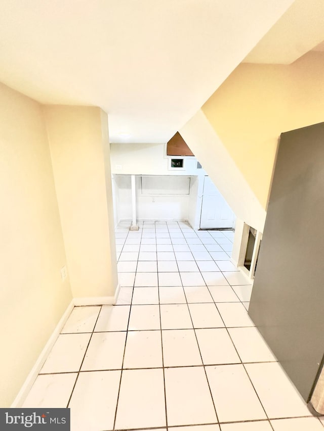 hall featuring light tile patterned floors