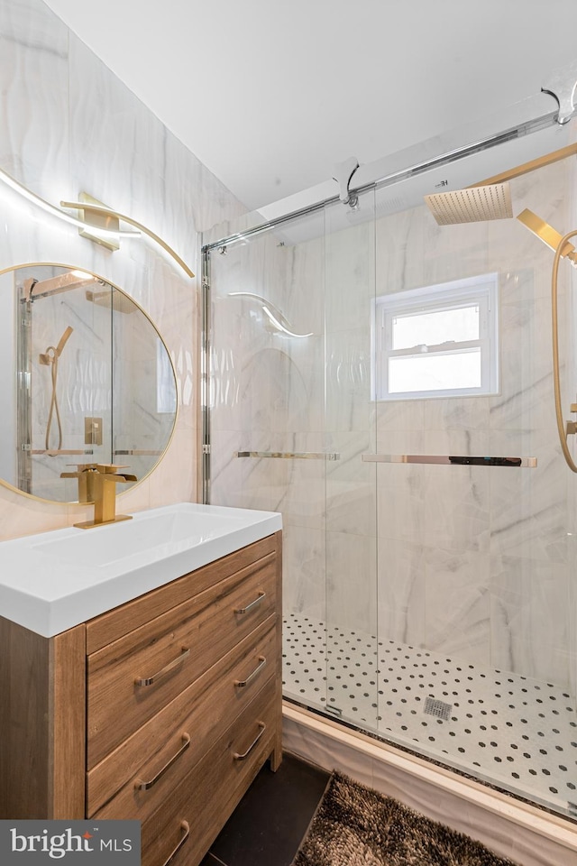 bathroom with walk in shower and vanity