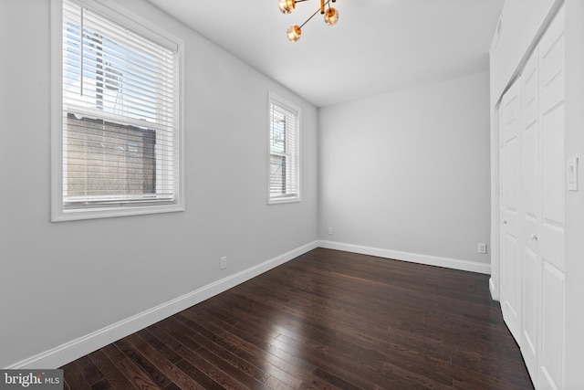 unfurnished bedroom with dark hardwood / wood-style flooring and a closet