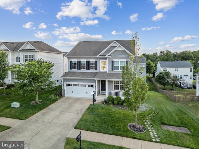 view of front of home with a garage, covered porch, and a front yard