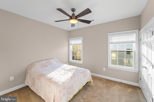 bedroom featuring light colored carpet and ceiling fan