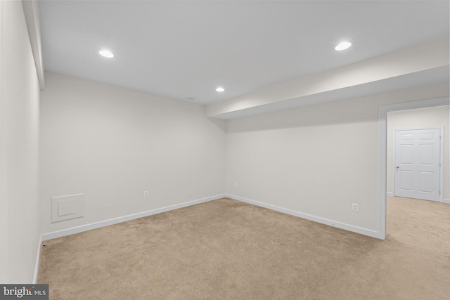 basement featuring light carpet