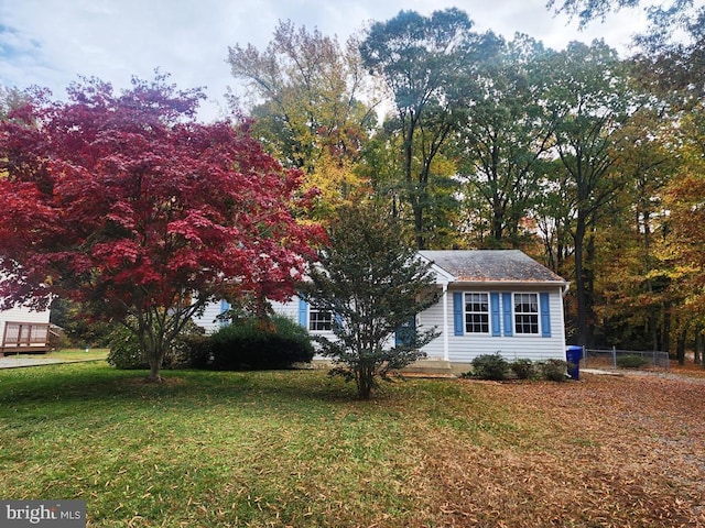 view of side of home with a yard