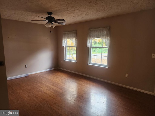 unfurnished room with hardwood / wood-style flooring, ceiling fan, and a textured ceiling