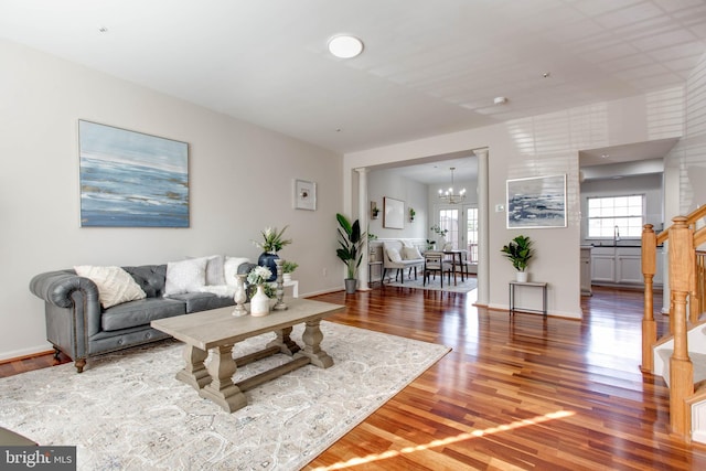 living room featuring a notable chandelier and hardwood / wood-style flooring