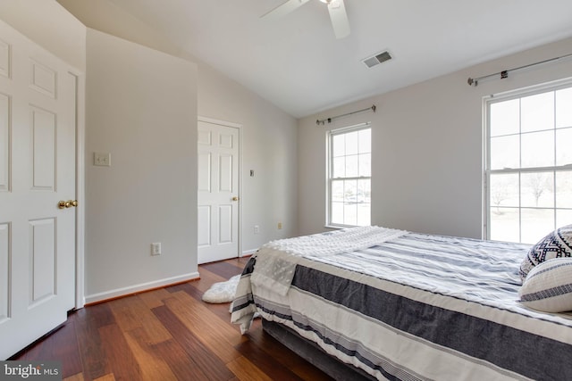 bedroom with ceiling fan, lofted ceiling, and dark hardwood / wood-style flooring