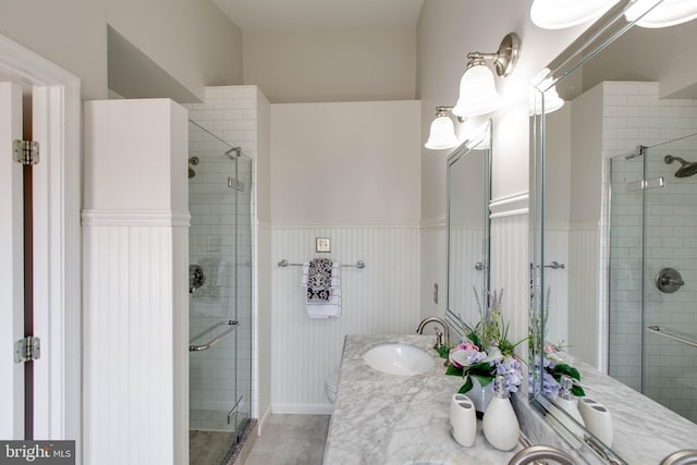 bathroom featuring vanity and an enclosed shower