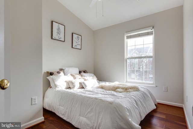 bedroom with dark wood-type flooring, ceiling fan, and lofted ceiling