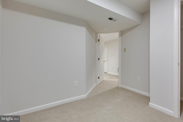 hall with light colored carpet