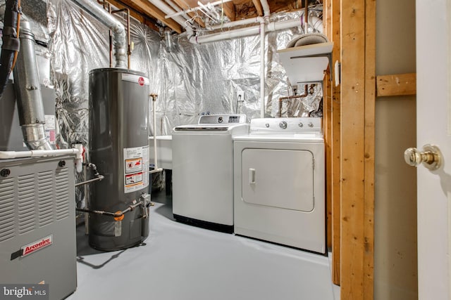 clothes washing area with water heater and independent washer and dryer