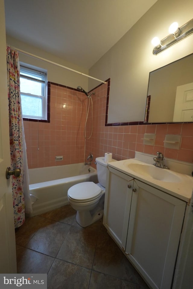 full bathroom with tile patterned floors, toilet, tile walls, vanity, and shower / bathtub combination with curtain