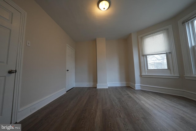 empty room featuring dark hardwood / wood-style flooring