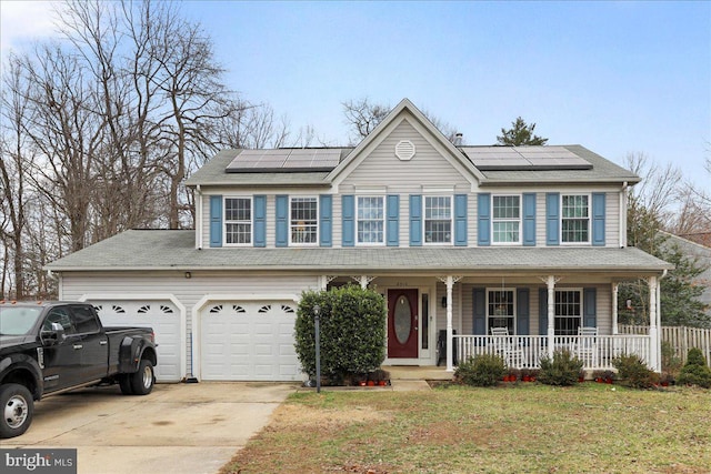 colonial inspired home with a front yard, solar panels, and a porch