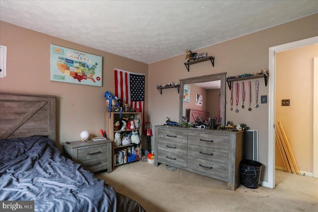 bedroom featuring carpet and a textured ceiling