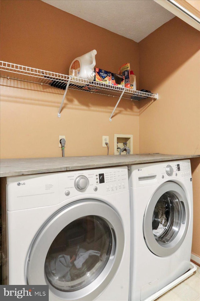 washroom featuring washing machine and dryer