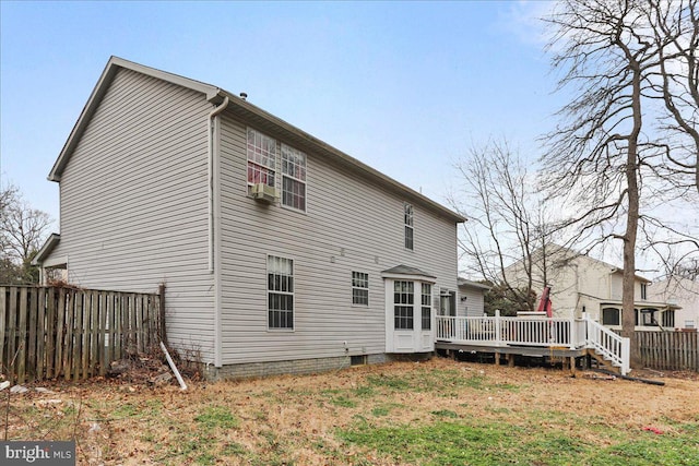 rear view of house with cooling unit and a deck