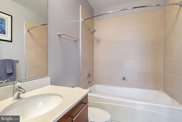 full bathroom with tiled shower / bath combo, vanity, and toilet