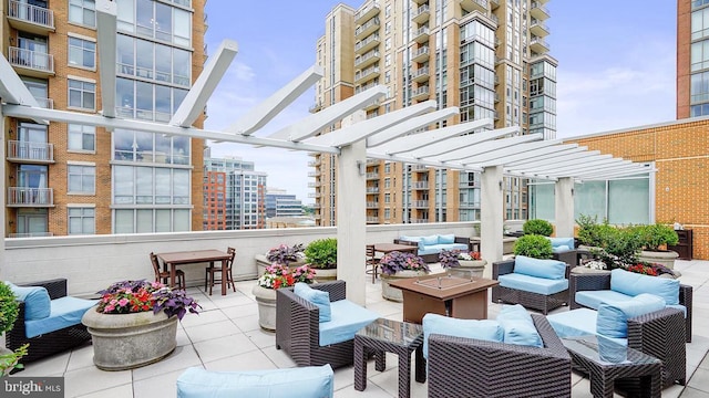 view of patio / terrace featuring a pergola and an outdoor living space with a fire pit