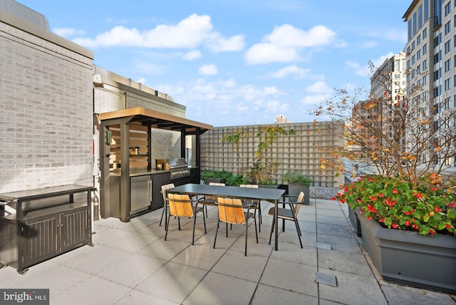 view of patio featuring a grill and an outdoor kitchen