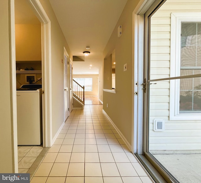 hallway with light tile patterned flooring and washer / clothes dryer