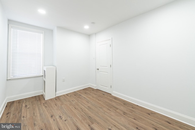 unfurnished room with hardwood / wood-style floors