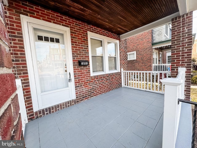 doorway to property featuring covered porch