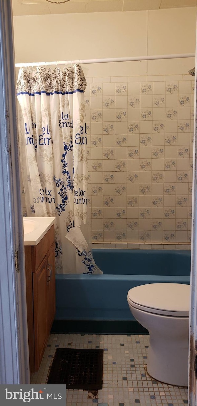 full bathroom with vanity, shower / bath combo, tile patterned floors, and toilet