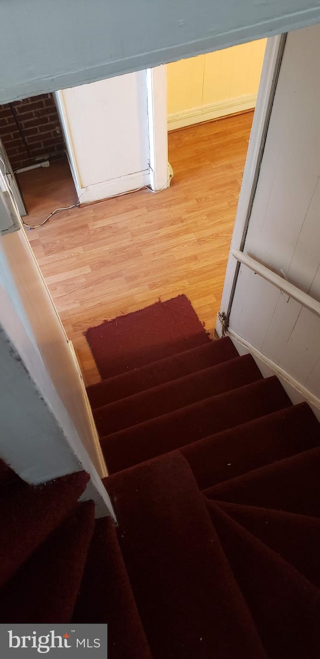 stairs featuring hardwood / wood-style floors