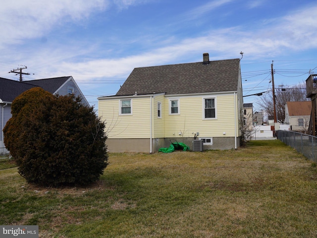 rear view of property featuring a yard