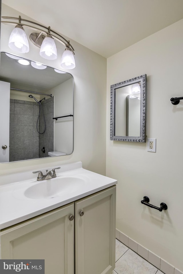 full bath featuring tile patterned flooring, vanity, and a shower