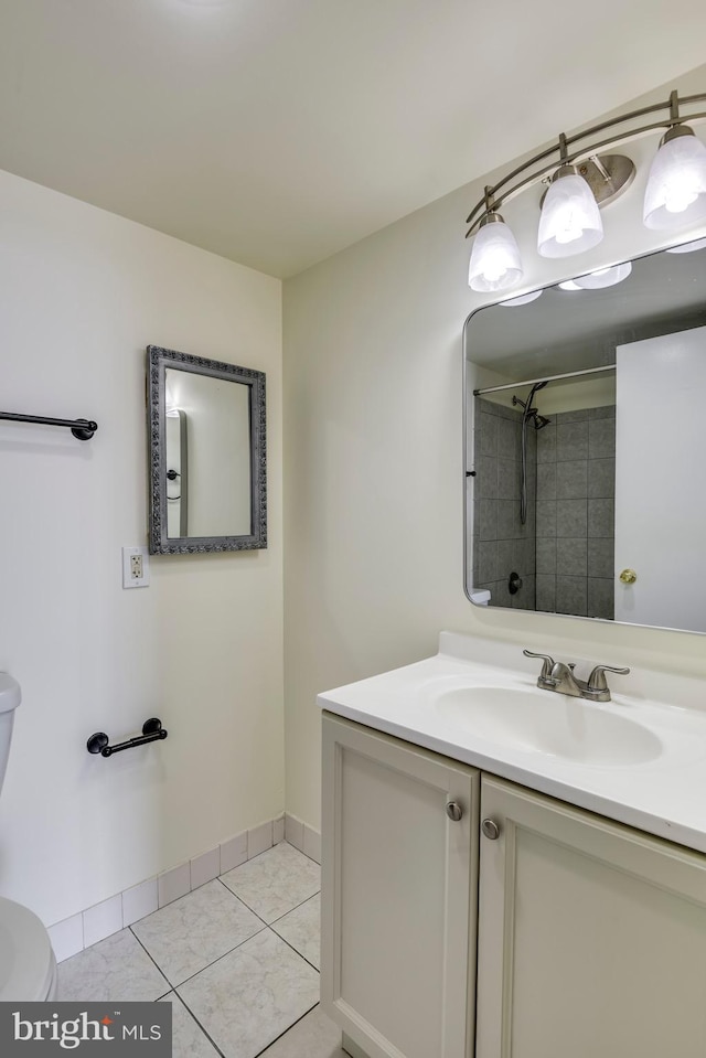 full bath with tile patterned flooring, baseboards, toilet, a tile shower, and vanity