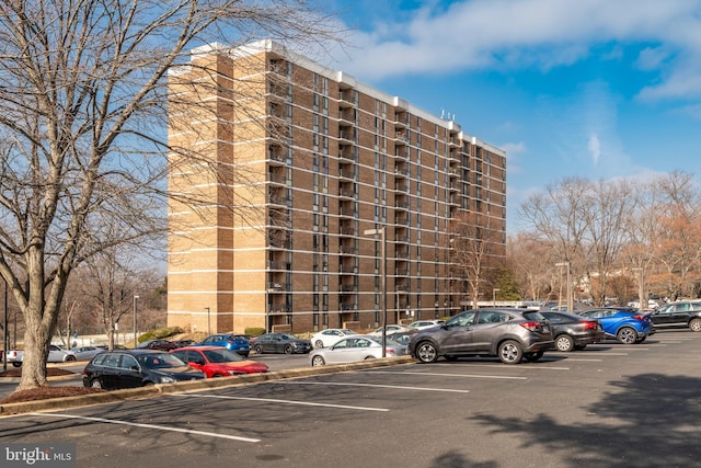 view of building exterior with uncovered parking