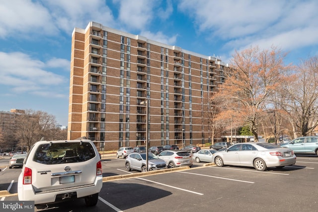 view of building exterior with uncovered parking