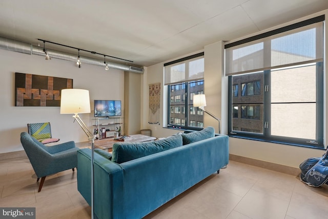 tiled living room featuring rail lighting