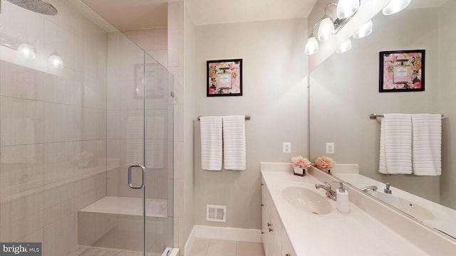 bathroom featuring vanity, tile patterned floors, and a shower with shower door