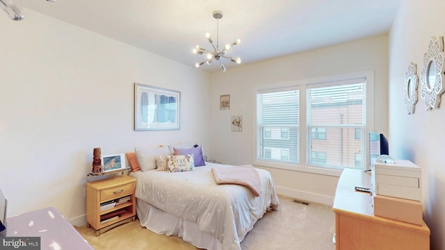 carpeted bedroom featuring a chandelier