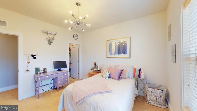 bedroom featuring an inviting chandelier and light colored carpet