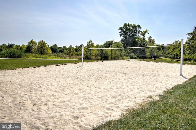 view of community featuring volleyball court and a lawn