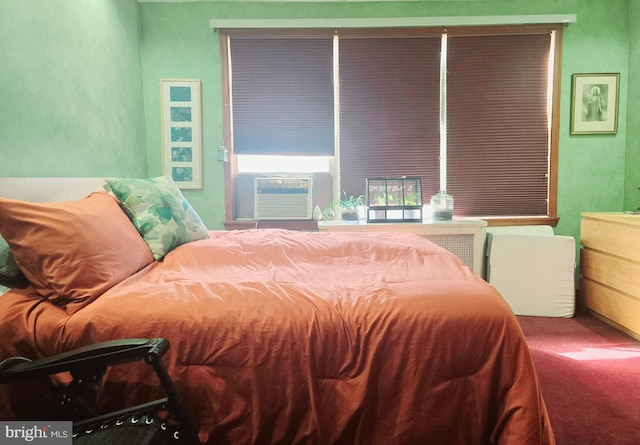 bedroom featuring carpet flooring and an AC wall unit