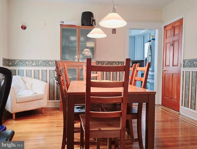 dining space with hardwood / wood-style flooring