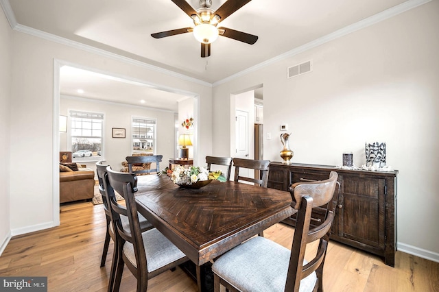 dining area featuring ornamental molding, ceiling fan, and light hardwood / wood-style flooring