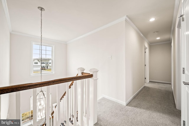 hall featuring an inviting chandelier, ornamental molding, and light carpet