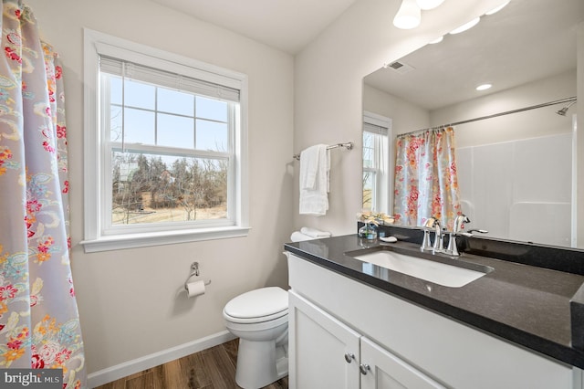 bathroom featuring wood-type flooring, toilet, a shower with shower curtain, and vanity