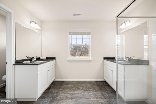 bathroom with vanity and toilet