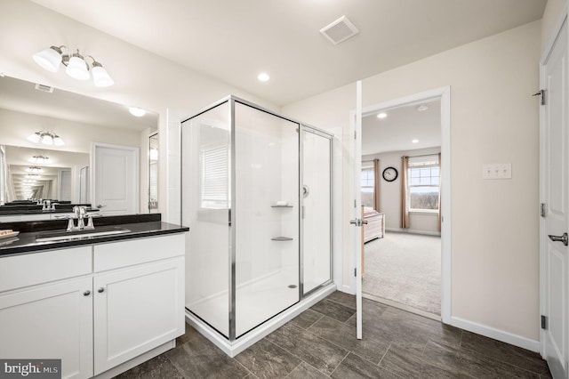 bathroom with vanity and a shower with shower door