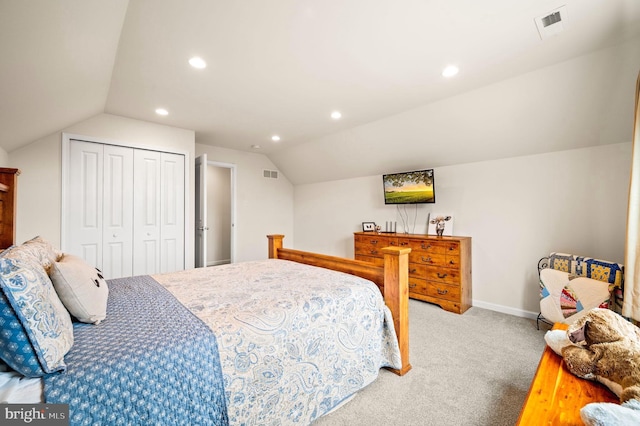 bedroom featuring a closet, vaulted ceiling, and carpet