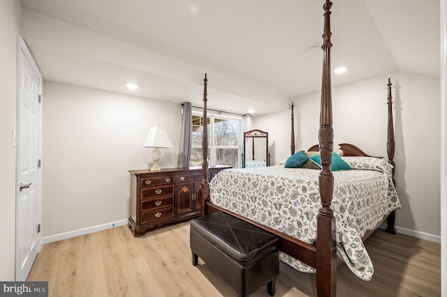 bedroom with lofted ceiling and light hardwood / wood-style flooring