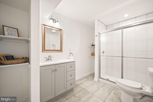 bathroom with vanity, toilet, tile patterned floors, and a shower with shower door